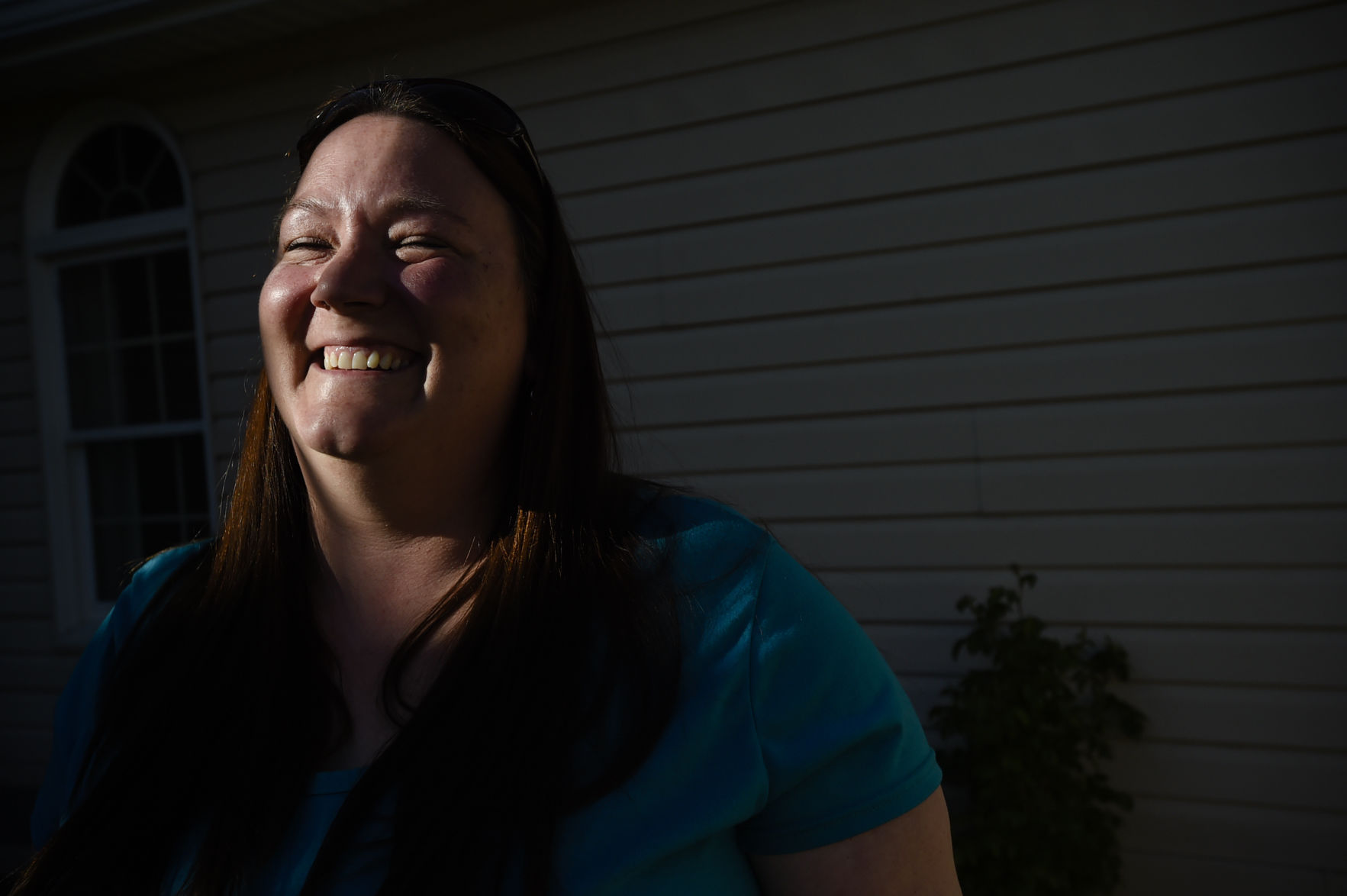 Linda smiles in the sunlight.